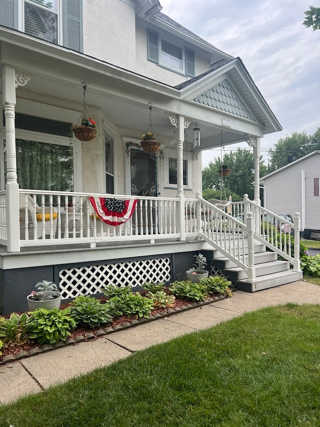 view of exterior entry with covered porch