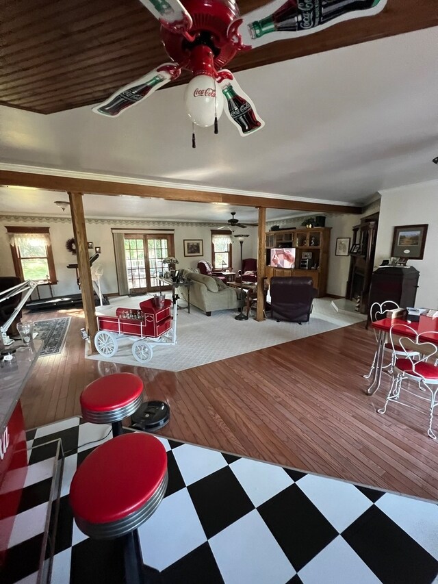 living room with light colored carpet, ceiling fan, and ornamental molding