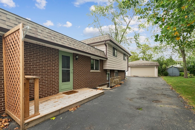 view of property exterior with a shed and a garage