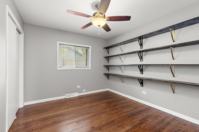 interior space featuring ceiling fan, a closet, and dark hardwood / wood-style flooring