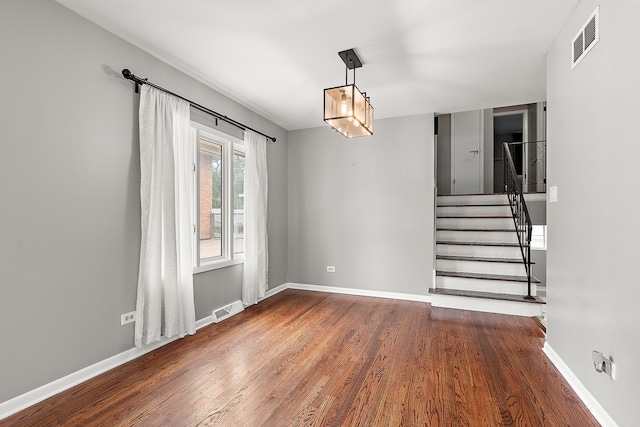 unfurnished room with dark hardwood / wood-style floors