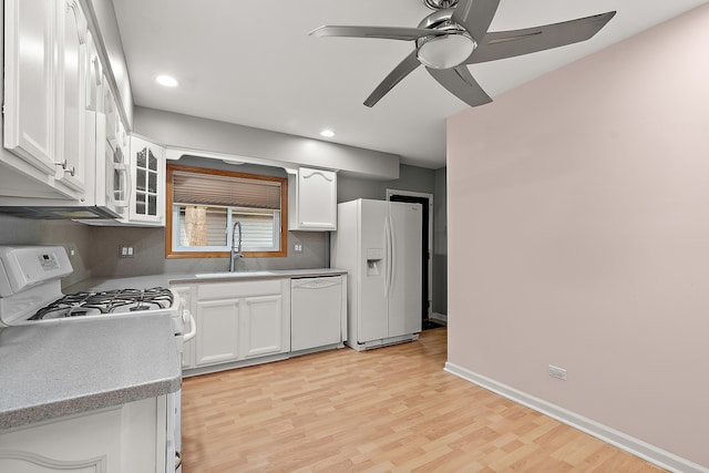 kitchen featuring ceiling fan, sink, white appliances, light hardwood / wood-style flooring, and white cabinetry