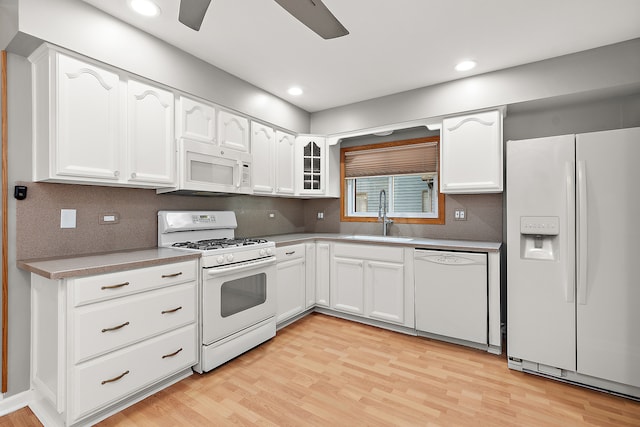 kitchen with white cabinetry, white appliances, light wood-type flooring, ceiling fan, and sink