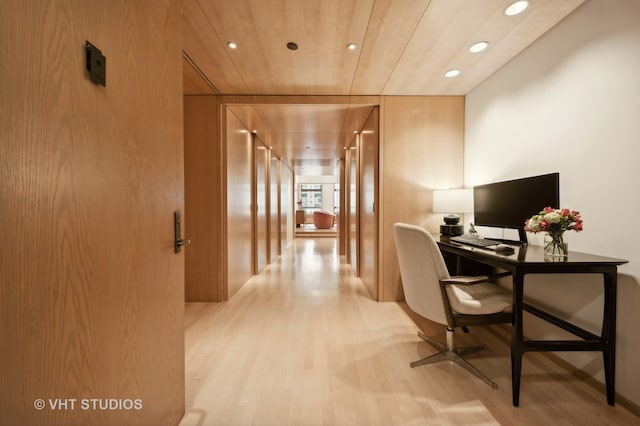 office with light wood-type flooring and wooden ceiling