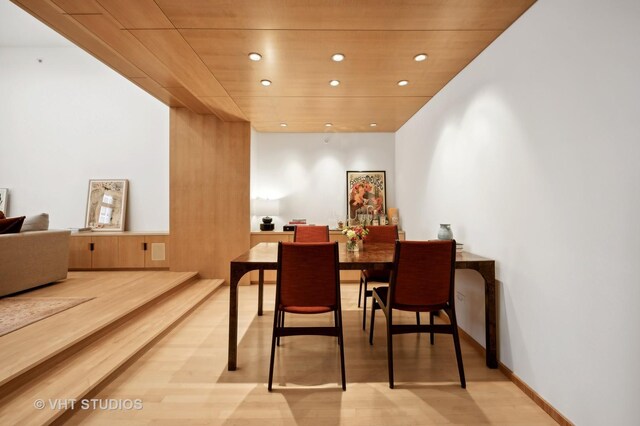 dining area with wood ceiling and hardwood / wood-style floors