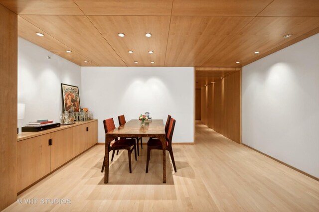 dining space with light wood-type flooring and wood ceiling