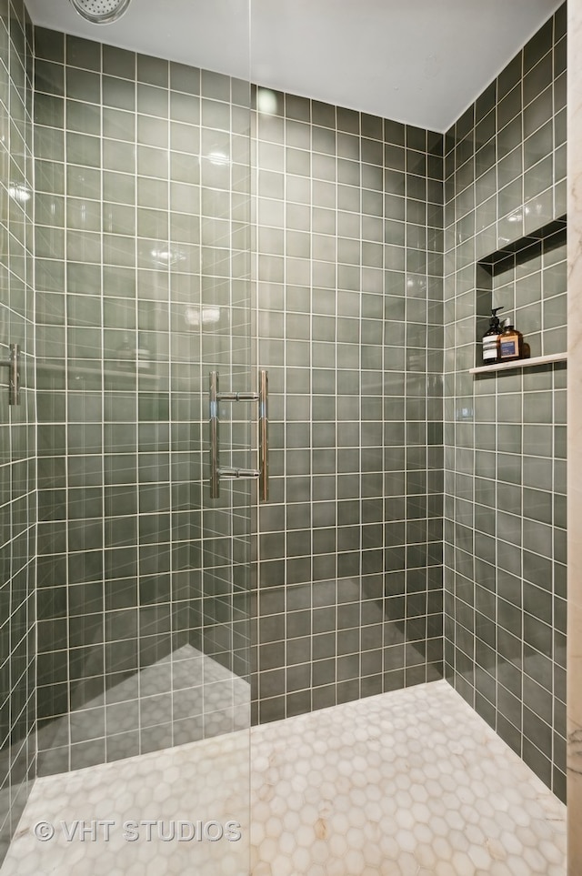 bathroom featuring a shower with door