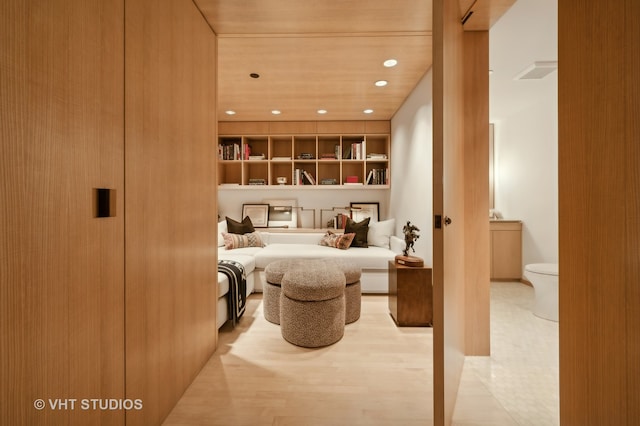 interior space with hardwood / wood-style floors and toilet