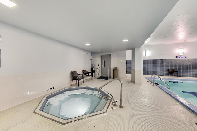 view of pool with an indoor hot tub