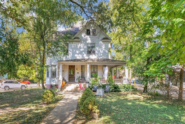 view of front facade featuring covered porch and a front yard