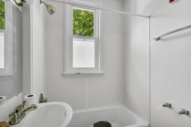 bathroom with washtub / shower combination and sink