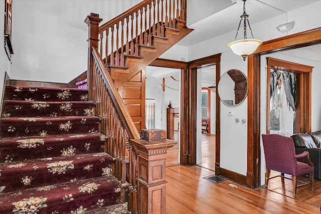 stairway with hardwood / wood-style flooring