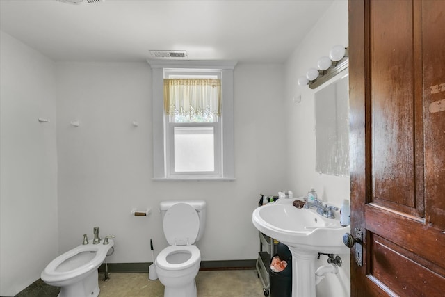 bathroom featuring toilet and a bidet