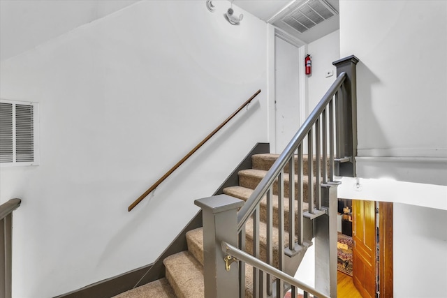 stairway featuring hardwood / wood-style flooring