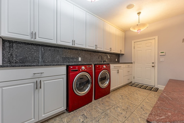 washroom with cabinets and washing machine and clothes dryer