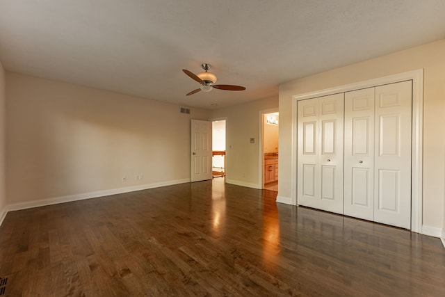 unfurnished bedroom with a closet, ceiling fan, and dark hardwood / wood-style floors