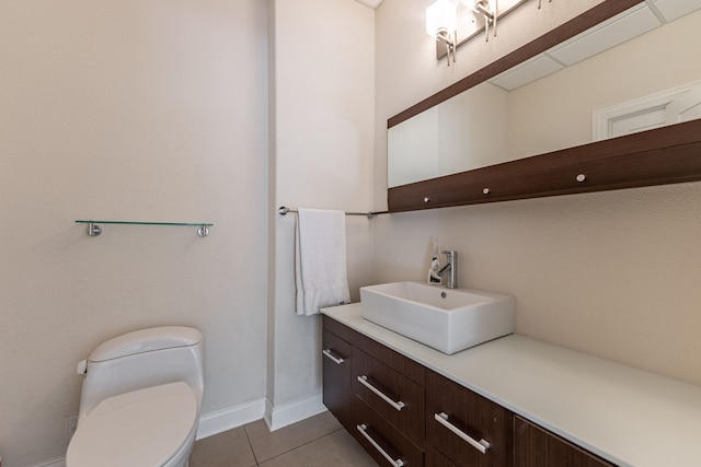 bathroom featuring tile patterned flooring, vanity, and toilet