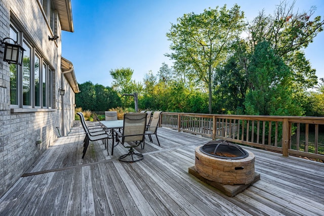 wooden deck featuring an outdoor fire pit