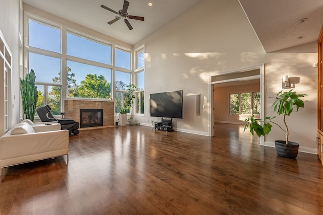 living room featuring high vaulted ceiling, a wealth of natural light, ceiling fan, and dark wood-type flooring