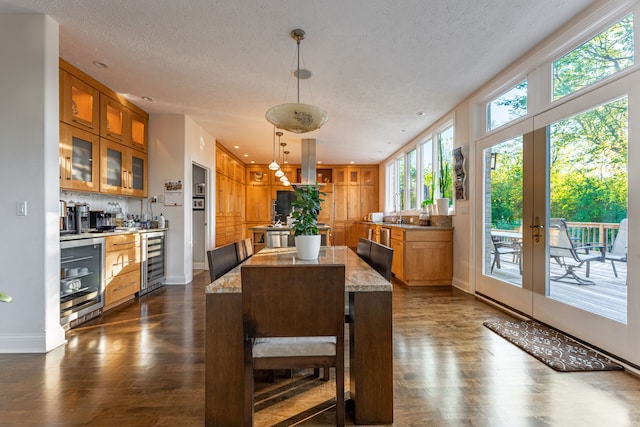 dining room featuring a textured ceiling, dark hardwood / wood-style flooring, and wine cooler