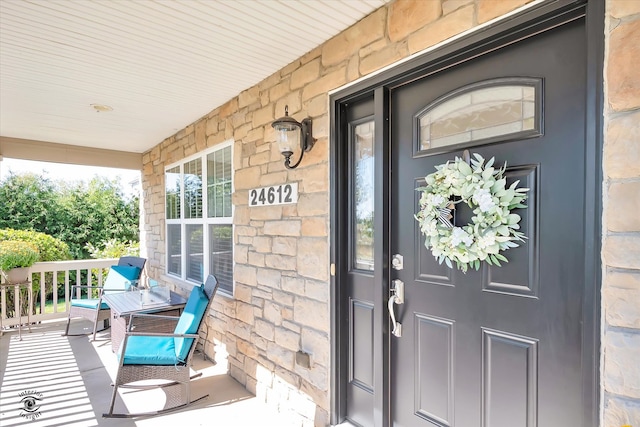 doorway to property with covered porch