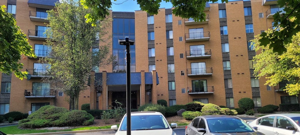 700 N Bruce Ln Unit 201, Glenwood, IL 60425 - view of apartment building / complex with uncovered parking