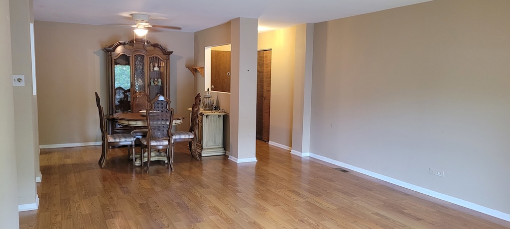 dining room with ceiling fan and light hardwood / wood-style floors