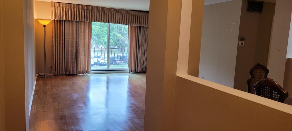 700 N Bruce Ln Unit 201, Glenwood, IL 60425 - spare room with wood finished floors