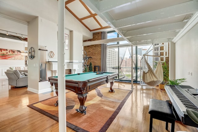 game room featuring hardwood / wood-style flooring, beam ceiling, pool table, and high vaulted ceiling