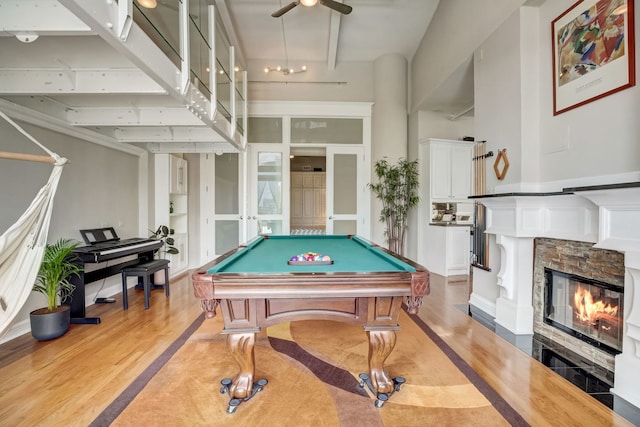 recreation room with light hardwood / wood-style floors, a fireplace, ceiling fan, and billiards