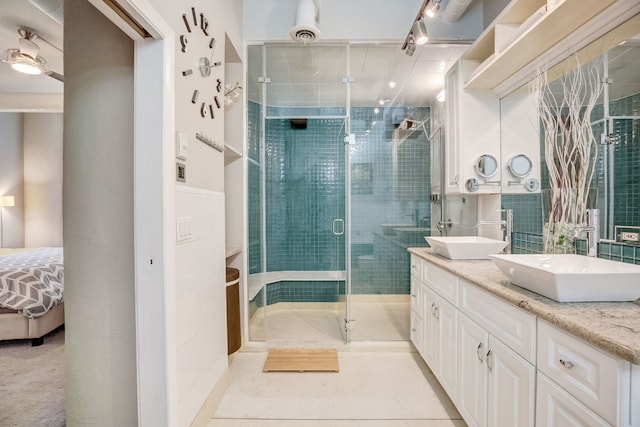 bathroom featuring walk in shower and vanity