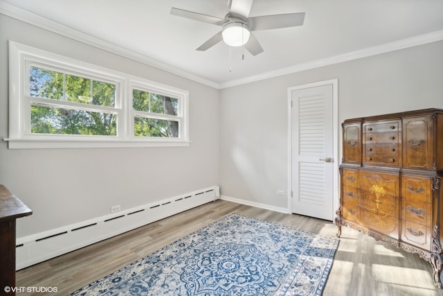 bedroom with light hardwood / wood-style flooring, ceiling fan, baseboard heating, and crown molding