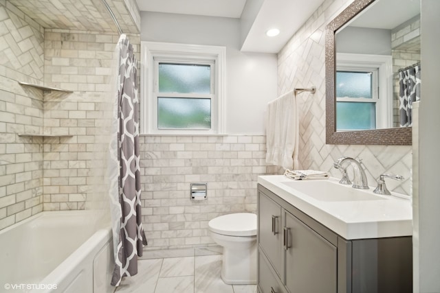 full bathroom featuring shower / bath combo with shower curtain, tile walls, vanity, and toilet