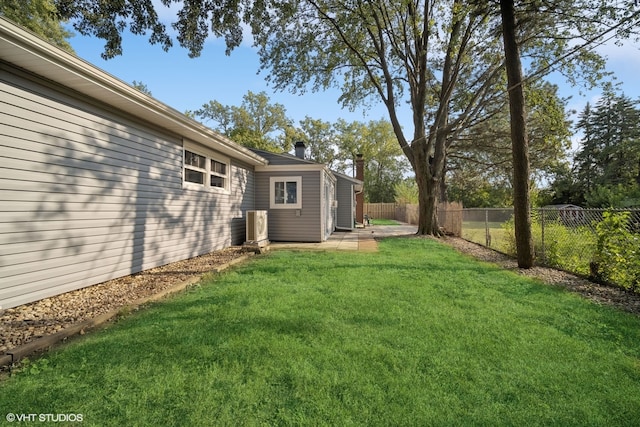 view of yard with central AC and a patio area