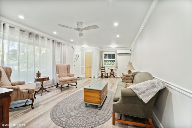 living area with light hardwood / wood-style floors, a wall unit AC, ceiling fan, and crown molding