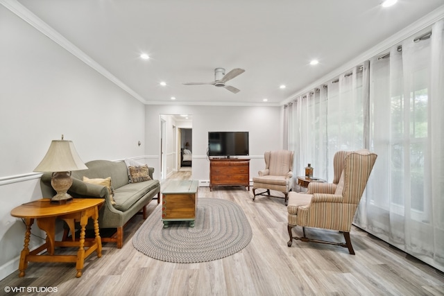 living room with light wood-type flooring, crown molding, and ceiling fan