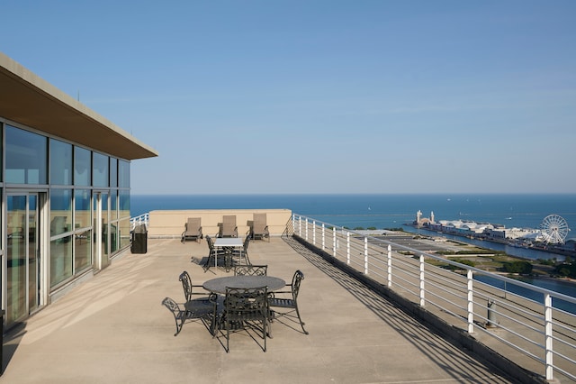 view of patio / terrace with a balcony and a water view