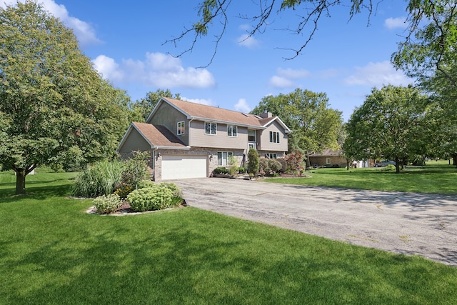 raised ranch with a garage and a front lawn