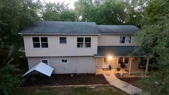 rear view of property featuring a patio area