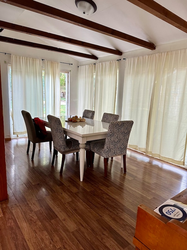 dining space featuring wood-type flooring and lofted ceiling with beams