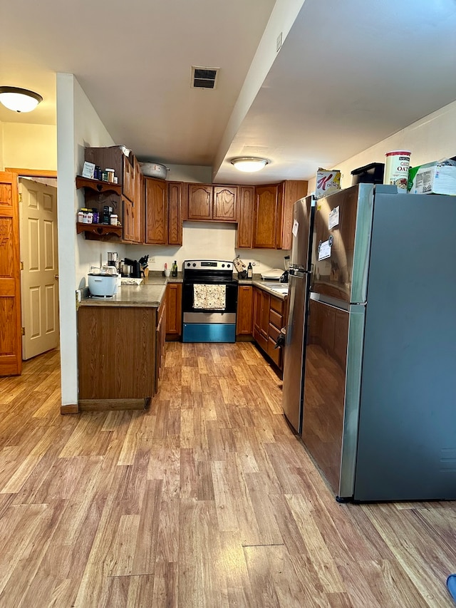 kitchen with light wood-type flooring and stainless steel appliances