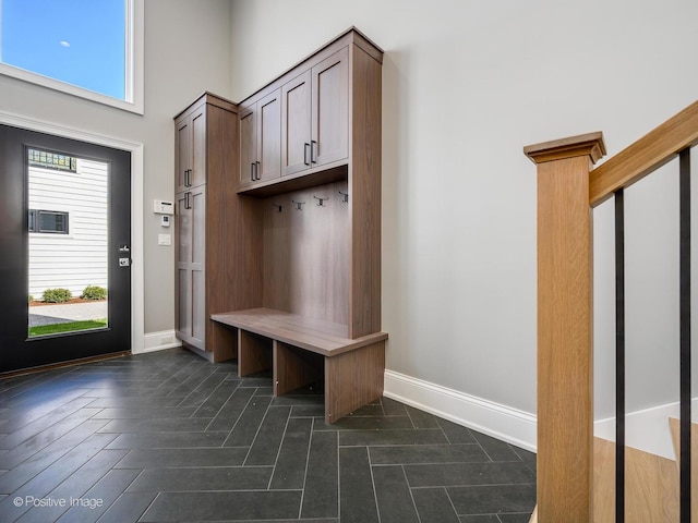 mudroom featuring a high ceiling