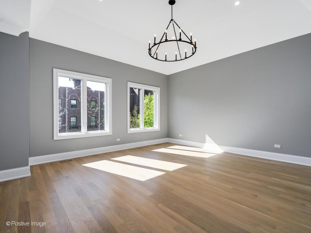 interior space featuring hardwood / wood-style floors and a notable chandelier