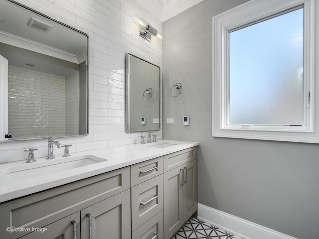 bathroom featuring tasteful backsplash and vanity