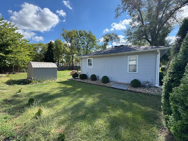 exterior space with a storage shed and a lawn