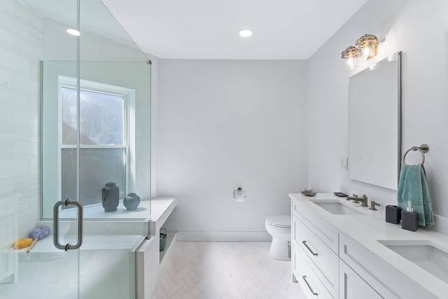 bathroom featuring vanity, toilet, and a shower with door