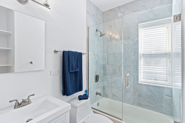 full bathroom with shower / bath combination with glass door, vanity, and toilet