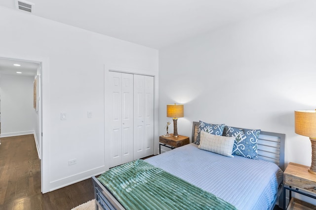 bedroom with a closet and dark wood-type flooring