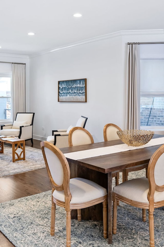 dining room featuring ornamental molding and hardwood / wood-style floors