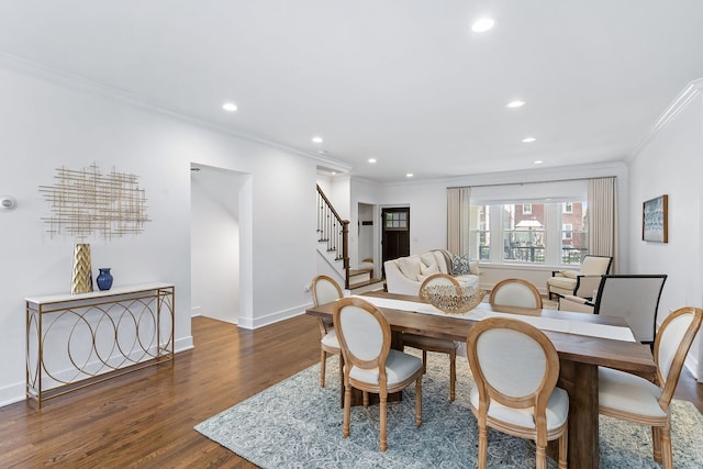 dining area featuring ornamental molding and dark wood-type flooring